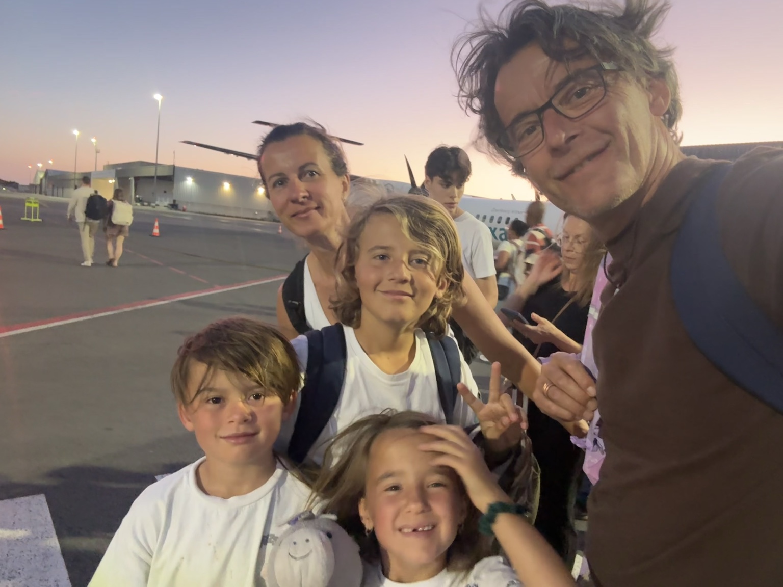 Familie vor dem Flugzeug auf einer gemeinsamen Reise, Amex Business Platinum Erfahrungen